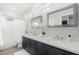 Clean bathroom with double vanity, white subway tile, and grey cabinets at 32427 N 71St Way, Scottsdale, AZ 85266