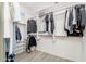 Large walk-in closet with ample shelving and hanging space at 32427 N 71St Way, Scottsdale, AZ 85266