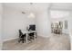 Modern dining room with hardwood floors and a view into the kitchen at 32427 N 71St Way, Scottsdale, AZ 85266