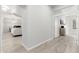 Bright hallway with light wood floors and access to various rooms at 32427 N 71St Way, Scottsdale, AZ 85266