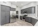 Updated kitchen with gray cabinets, stainless steel appliances, and a large refrigerator at 32427 N 71St Way, Scottsdale, AZ 85266