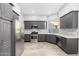 Modern kitchen with gray cabinets, stainless steel appliances, and white countertops at 32427 N 71St Way, Scottsdale, AZ 85266