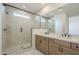 Bathroom with marble shower, double vanity, and modern fixtures at 12028 N Luckenbach St, Surprise, AZ 85388