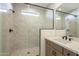 Bathroom with marble shower, vanity, and modern fixtures at 12028 N Luckenbach St, Surprise, AZ 85388