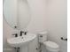 Stylish powder room with pedestal sink and toilet at 12028 N Luckenbach St, Surprise, AZ 85388