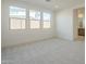 Spacious bedroom with three windows and grey carpet at 12028 N Luckenbach St, Surprise, AZ 85388