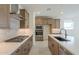 Modern kitchen with wood cabinetry, island, and stainless steel appliances at 12028 N Luckenbach St, Surprise, AZ 85388