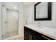 Clean bathroom with a walk-in shower, quartz countertop and dark vanity at 13503 E Charter Oak Dr, Scottsdale, AZ 85259