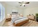 Bright bedroom with wood-framed bed, neutral decor, and window shutters at 13503 E Charter Oak Dr, Scottsdale, AZ 85259