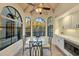 Bright breakfast nook with a glass table and chairs, built in microwave and cabinets at 13503 E Charter Oak Dr, Scottsdale, AZ 85259