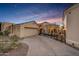 Front view of house with driveway and wrought iron gate at 13503 E Charter Oak Dr, Scottsdale, AZ 85259