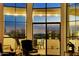 Relaxing living room with access to a balcony and city views at dusk at 13503 E Charter Oak Dr, Scottsdale, AZ 85259