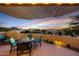 Outdoor patio with fire pit and beautiful sunset views at 13503 E Charter Oak Dr, Scottsdale, AZ 85259