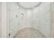 Large shower with marble tile and glass enclosure at 13503 E Charter Oak Dr, Scottsdale, AZ 85259