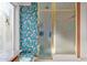Well-lit bathroom with a shower, floral wallpaper, window bench and convenient features at 15233 N 5Th Ave, Phoenix, AZ 85023