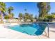Refreshing community pool surrounded by palm trees offering a serene escape with plenty of space for swimming and lounging at 15233 N 5Th Ave, Phoenix, AZ 85023