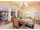 Inviting dining room featuring stylish chandelier, wood table with seating for six and access to living area at 15233 N 5Th Ave, Phoenix, AZ 85023