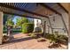 Landscaped backyard patio with wood beam pergola and decorative water feature at 15233 N 5Th Ave, Phoenix, AZ 85023