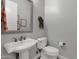 Small bathroom with pedestal sink and toilet at 17408 N 96Th Way, Scottsdale, AZ 85255