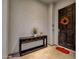 Entryway with console table, dark wood door, and fall decor at 17408 N 96Th Way, Scottsdale, AZ 85255