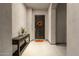 Home entryway with console table and dark wood door at 17408 N 96Th Way, Scottsdale, AZ 85255