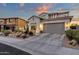 Two-story home with gray garage door and desert landscaping at 17408 N 96Th Way, Scottsdale, AZ 85255