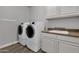 Laundry room with washer, dryer, and extra counter space at 17408 N 96Th Way, Scottsdale, AZ 85255