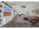 Living room with built-in shelving, large TV, and open floor plan at 17408 N 96Th Way, Scottsdale, AZ 85255