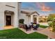 Patio with seating area and artificial turf, next to home entrance at 17408 N 96Th Way, Scottsdale, AZ 85255