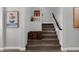 Modern staircase with carpet runner and stylish wall art at 17408 N 96Th Way, Scottsdale, AZ 85255