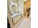 Bright bathroom with marble floors, a modern vanity, and a glass-enclosed shower at 20668 E Sunset Dr, Queen Creek, AZ 85142