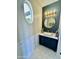 Chic powder room with an oval window, a unique vanity, and modern fixtures at 20668 E Sunset Dr, Queen Creek, AZ 85142