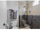 Bathroom with shower, toilet, and tiled walls at 20668 E Sunset Dr, Queen Creek, AZ 85142