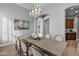 Elegant dining room features a large table, chandelier, and hardwood floors at 20668 E Sunset Dr, Queen Creek, AZ 85142