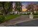 Elegant home exterior with a grand entrance and manicured lawn at 20668 E Sunset Dr, Queen Creek, AZ 85142