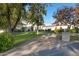 Stunning home with a brick paver driveway and lush landscaping at 20668 E Sunset Dr, Queen Creek, AZ 85142