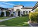 Luxury home with a welcoming entryway and manicured lawn at 20668 E Sunset Dr, Queen Creek, AZ 85142