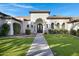 Home with arched entryway and meticulously landscaped grounds at 20668 E Sunset Dr, Queen Creek, AZ 85142