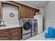 Bright laundry room with modern washer, dryer, and ample cabinetry at 20668 E Sunset Dr, Queen Creek, AZ 85142