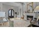 Elegant living room with a fireplace and a view to entry at 20668 E Sunset Dr, Queen Creek, AZ 85142