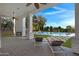 Covered patio with fireplace and lounge chairs, overlooking the pool at 20668 E Sunset Dr, Queen Creek, AZ 85142