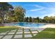 Inviting backyard oasis featuring a sparkling pool and lush landscaping at 20668 E Sunset Dr, Queen Creek, AZ 85142