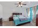 Primary bedroom with teal bedding and ceiling fan at 306 N 21St Cir, Coolidge, AZ 85128