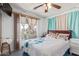 Bright bedroom with a double bed and teal bedding at 306 N 21St Cir, Coolidge, AZ 85128