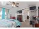 Primary bedroom with striped bedding and ensuite bathroom at 306 N 21St Cir, Coolidge, AZ 85128