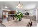 Bright dining room with a table for six and open kitchen views at 306 N 21St Cir, Coolidge, AZ 85128