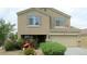 Two-story house with tan exterior, landscaped yard, and attached two-car garage at 306 N 21St Cir, Coolidge, AZ 85128