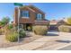 Two-story house with a tan exterior, two-car garage, and landscaping at 306 N 21St Cir, Coolidge, AZ 85128