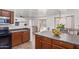 Open kitchen with dark wood cabinets, island and view of dining and living room at 306 N 21St Cir, Coolidge, AZ 85128