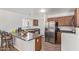 Modern kitchen with dark wood cabinets and breakfast bar at 306 N 21St Cir, Coolidge, AZ 85128